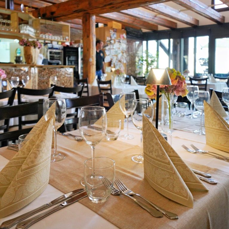 Architekturfotografie eines Restaurant-Innenraums mit gedeckten Tischen